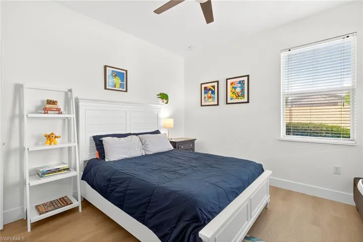 Guest Bedroom featuring light wood finished floors and a ceiling fan
