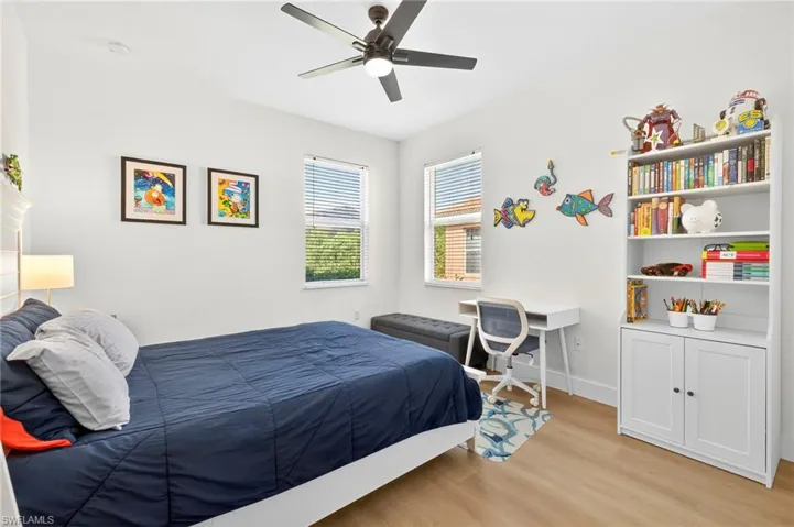 Guest Bedroom featuring light wood-style floors and ceiling fan