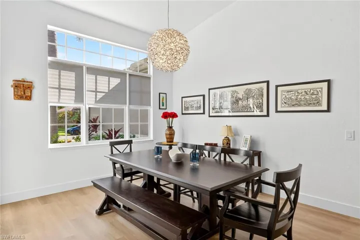 Dining area with light wood-style floors and baseboards