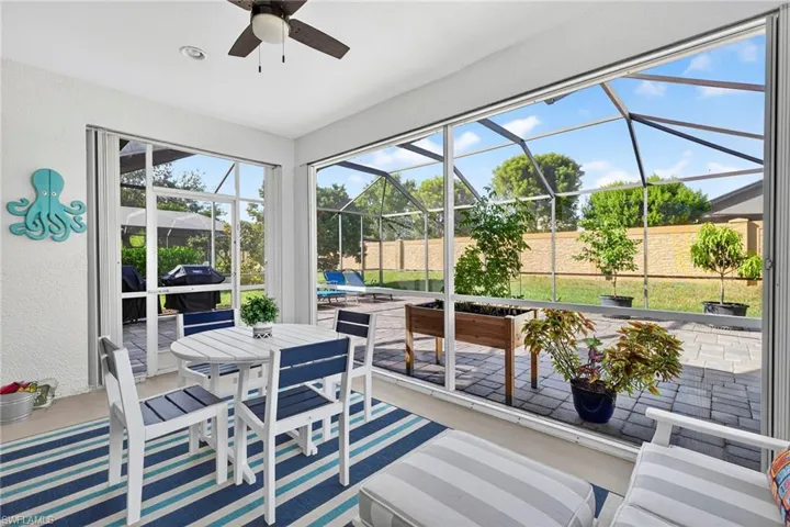 Lanai featuring a patio area, a ceiling fan, and outdoor dining area