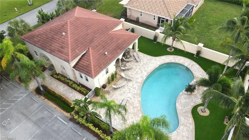 Aerial view of property and surrounding area featuring a pool area