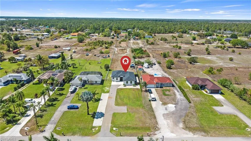 Aerial perspective of suburban area with a forest