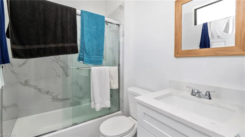 Full bathroom with vanity and shower / bath combination with glass door