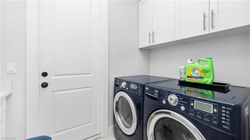 Laundry room with washing machine and clothes dryer and cabinet space