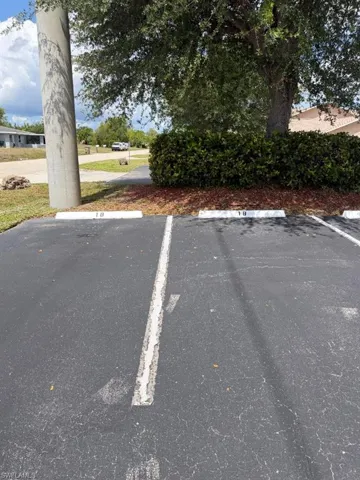 Paved parking area featuring designated spaces with numbered parking blocks
