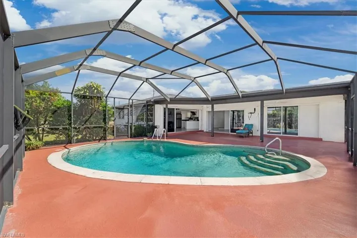 Pool with a lanai and a patio