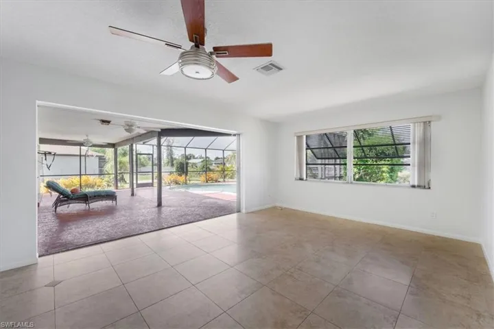 family room featuring visible vents, a ceiling fan, plenty of natural light, and a sunroom
