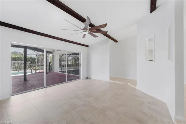 Unfurnished room with beamed ceiling, ceiling fan
