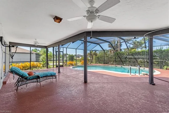 Outdoor pool with a patio area, a lanai, and a ceiling fan