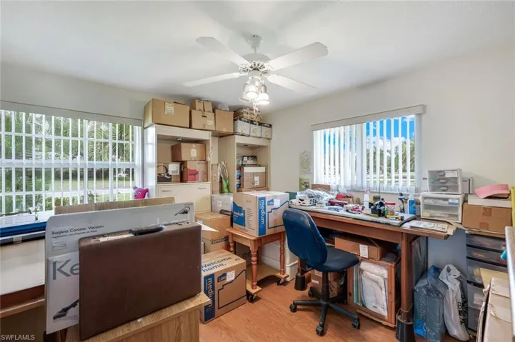 Office area featuring a wealth of natural light, light wood-style floors, and ceiling fan