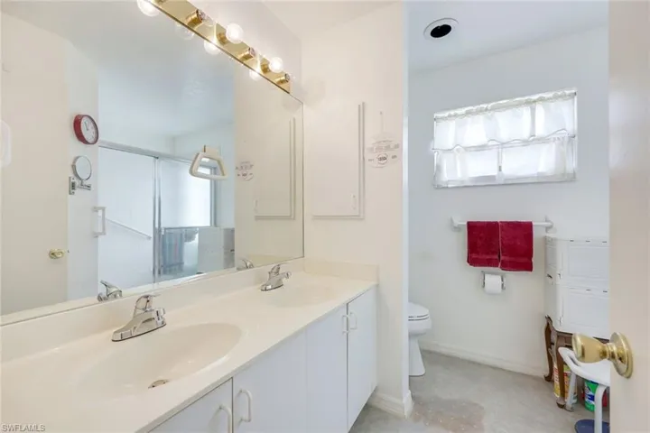 Bathroom with a shower stall, a wealth of natural light, and a sink