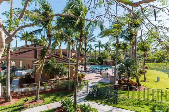 Surrounding community with a fenced front yard, a pool, and a gate