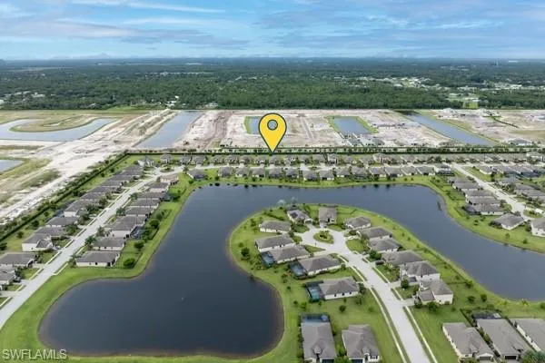 View of property location featuring a nearby body of water and nearby suburban area