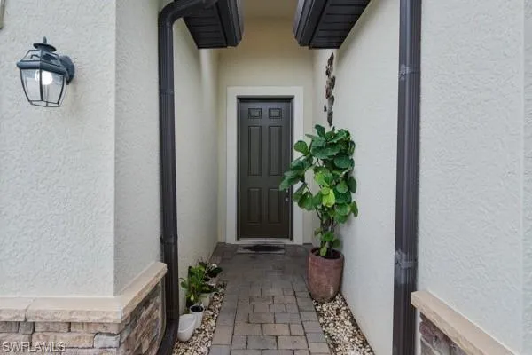 Property entrance featuring stucco siding