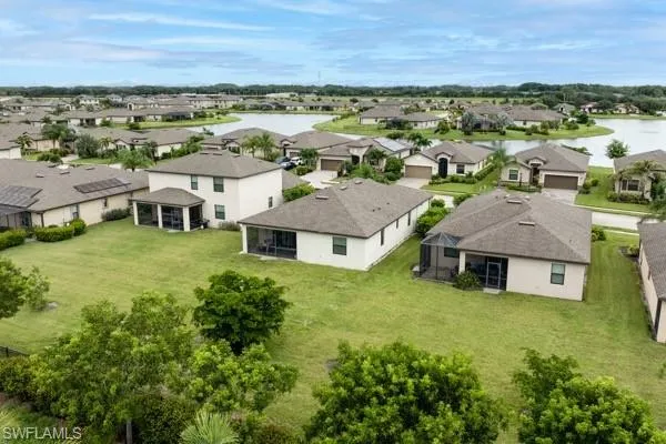 Aerial perspective of suburban area with a large body of water