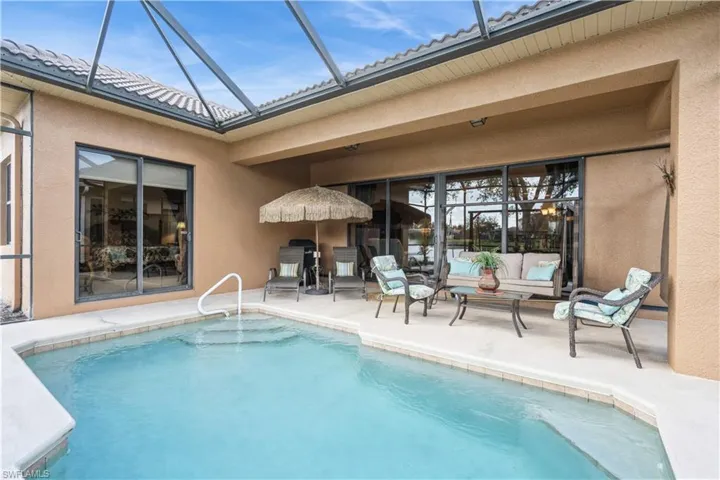 View of swimming pool featuring a lanai and a patio