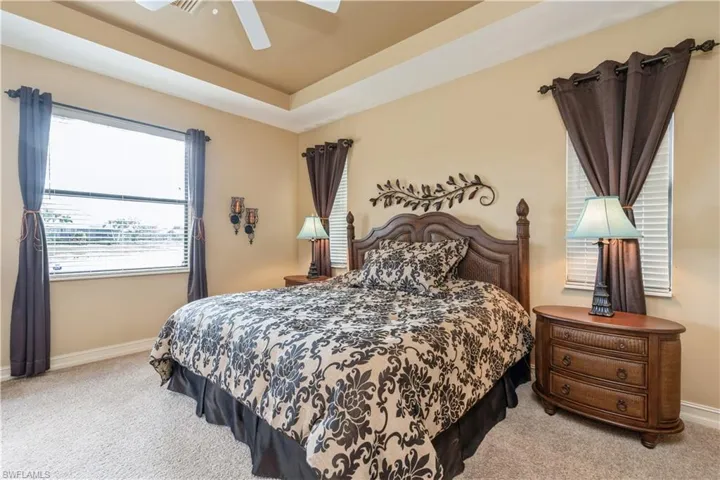 Carpeted bedroom with ceiling fan