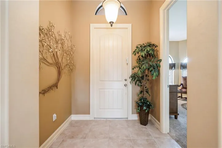 Entryway with light tile patterned floors