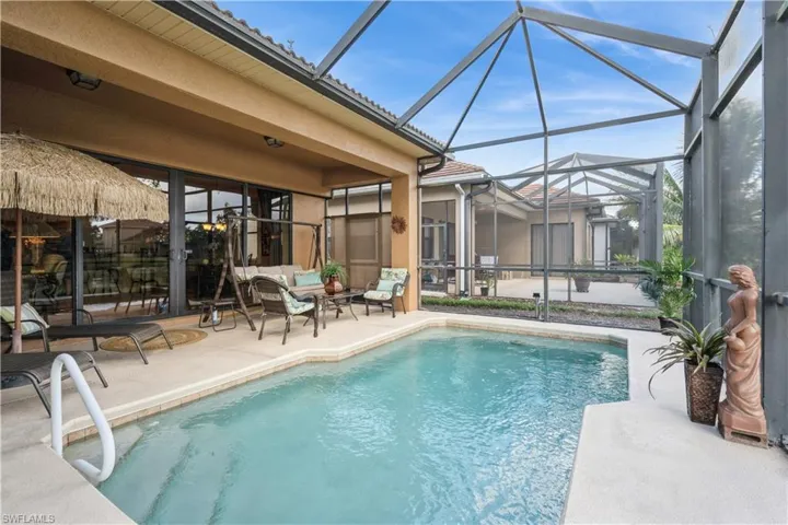 View of swimming pool featuring a lanai, an outdoor hangout area, and a patio