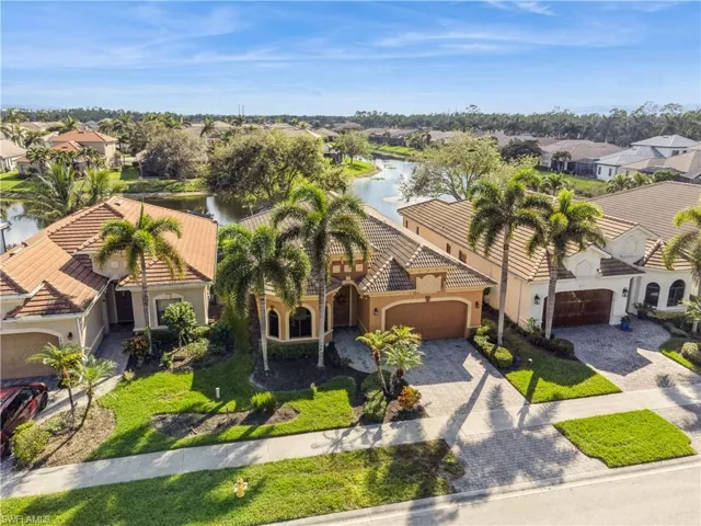 Birds eye view of property with a water view