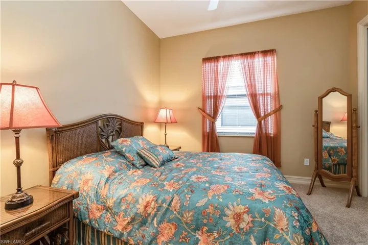 Bedroom with carpet, vaulted ceiling, and ceiling fan