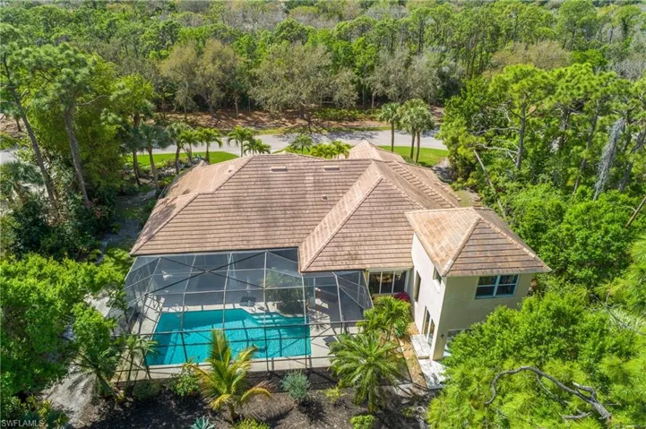 Aerial view of property and surrounding area featuring a pool area