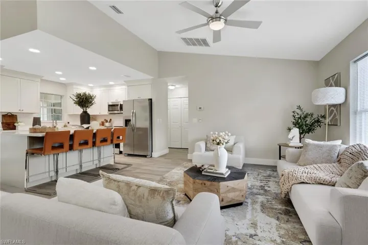 Open-concept living space featuring vaulted ceilings and wood-finish flooring