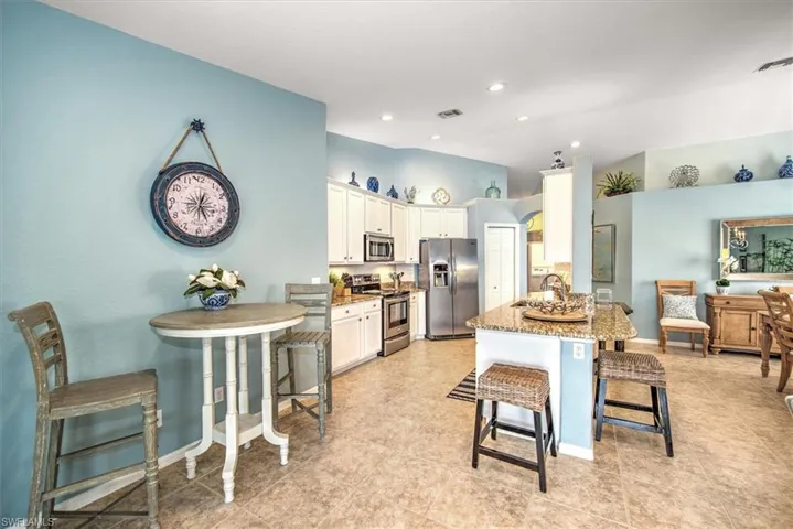 Kitchen with a breakfast bar and granite counters
