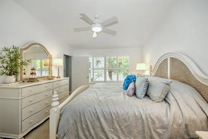 Primary Bedroom with Water View, vaulted ceiling, and ceiling fan
