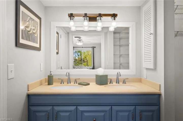 Bathroom with ceiling fan and vanity