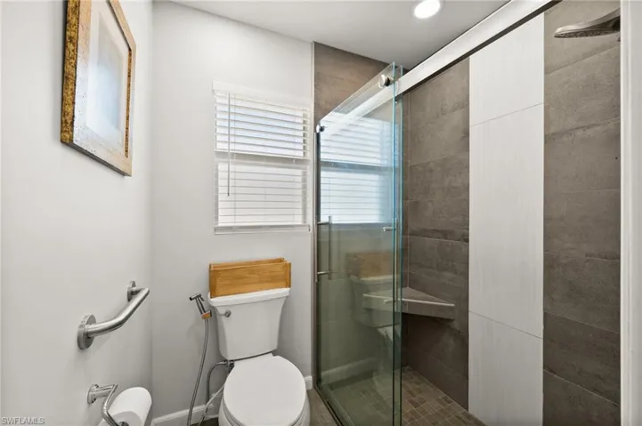 Bathroom featuring toilet and an enclosed shower