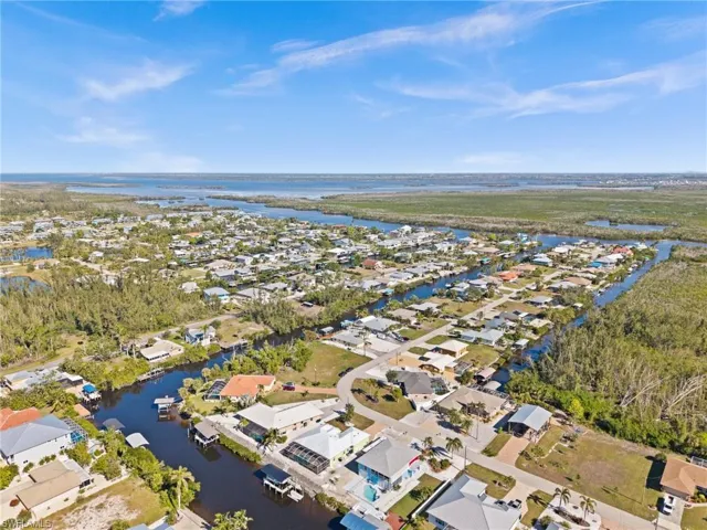 Birds eye view of property with a water view
