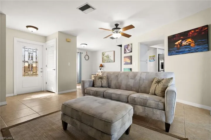 Living room featuring ceiling fan and light tile patterned flooring