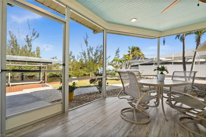 Sunroom featuring ceiling fan and plenty of natural light