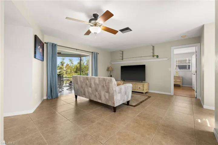 Tiled living room featuring ceiling fan