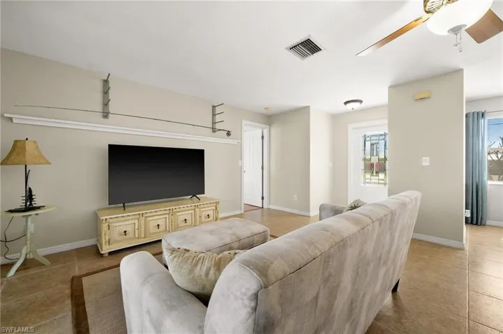 Tiled living room featuring a wealth of natural light