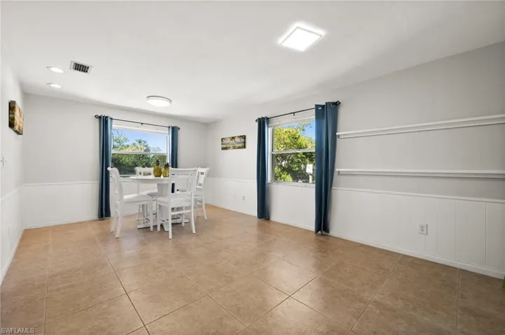 Unfurnished dining area with plenty of natural light and light tile patterned flooring