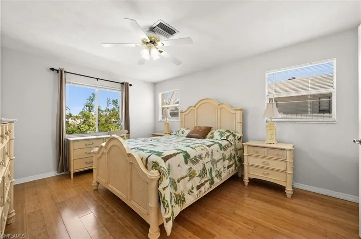 Bedroom with hardwood / wood-style flooring and ceiling fan