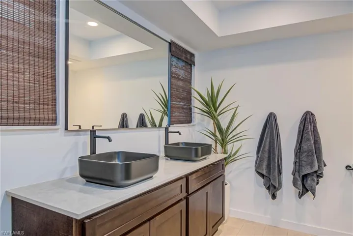 Remodeled with NEW windows, NEW shower, with double vanity, a raised ceiling, and recessed lighting