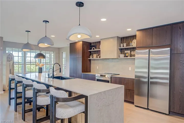 NEWLY REMODELED! Kitchen with stainless stove &  refrigerator, open shelves, modern cabinets, light countertops, and recessed lighting