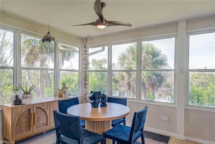 Sunroom featuring views and natural light just off living room/kitchen