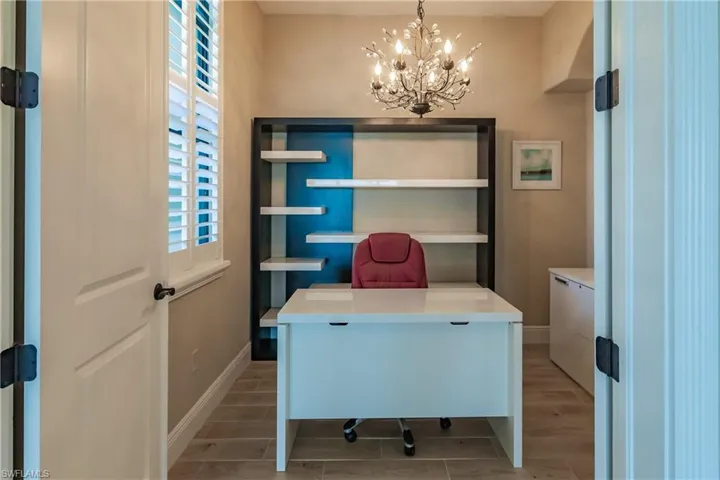 Home office featuring a chandelier