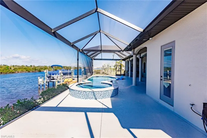 Swimming pool with hot tub, and a water view