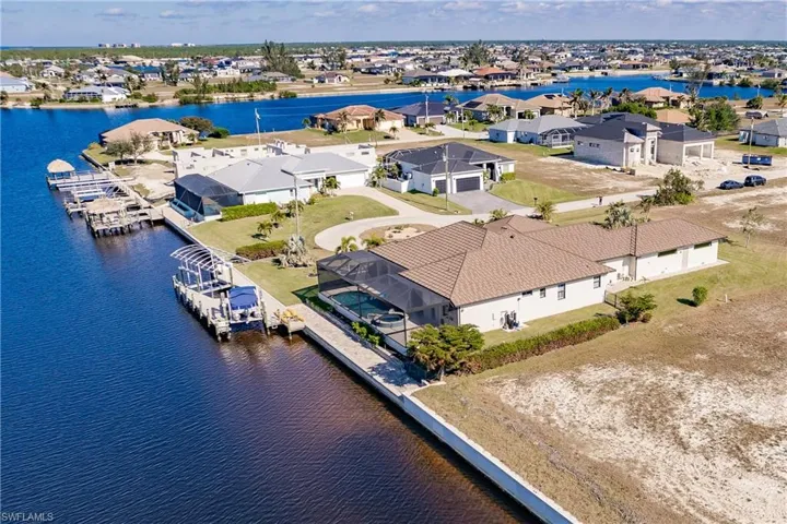 Birds eye view of property with  water view