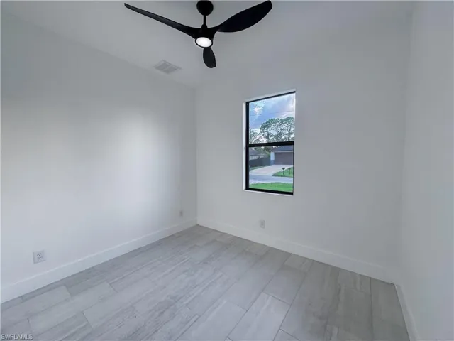 Empty room featuring a ceiling fan and light wood finished floors