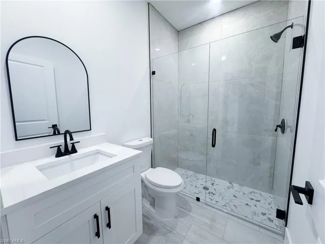 Bathroom with vanity and a shower stall