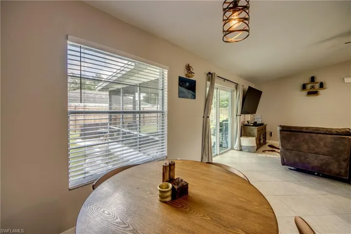 Tiled dining space with lofted ceiling