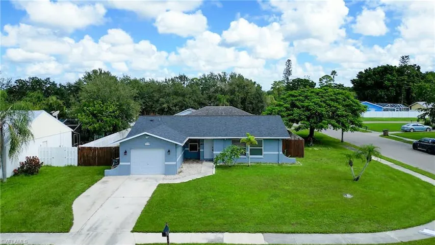 Ranch-style home with a garage and a front lawn