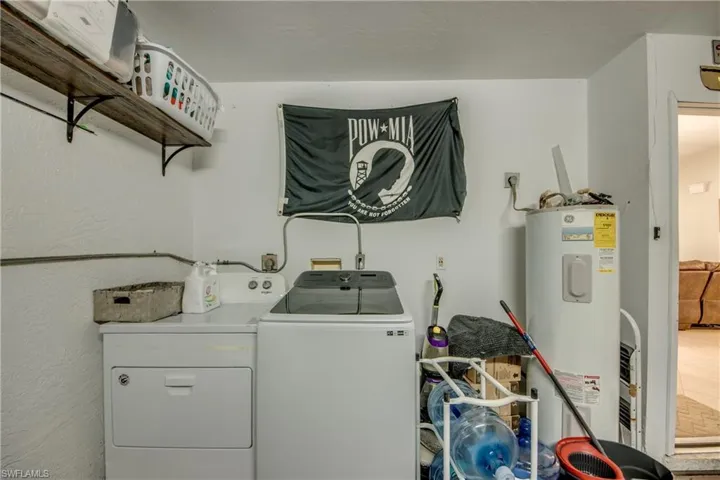 Laundry area with washer and dryer and water heater