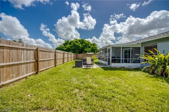 View of yard with a sunroom and a patio area
